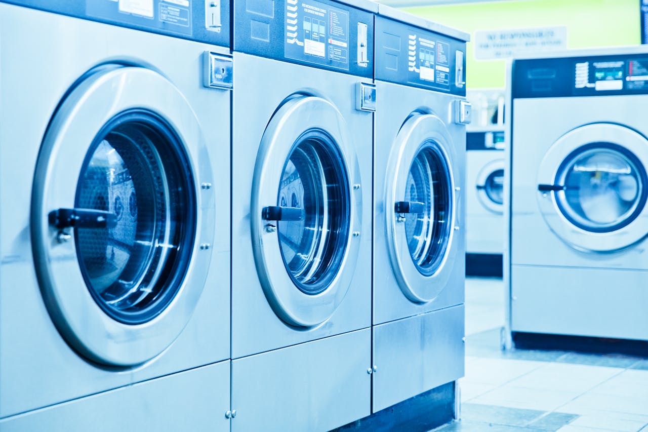 gallery-6 Row of industrial washing machines in a contemporary laundromat.